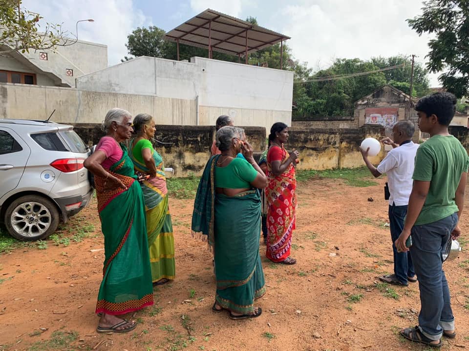 Women talking to Manick and questioning him about the eclipse